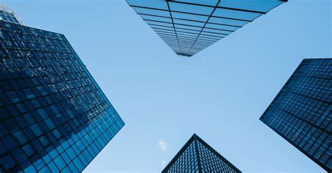 Contemporary Glass Skyscrapers Under Cloudless Blue Sky · Free Stock Photo