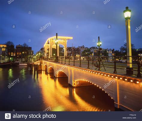 The Magere Brug Skinny Bridge At Dusk And River Amstel Amsterdam
