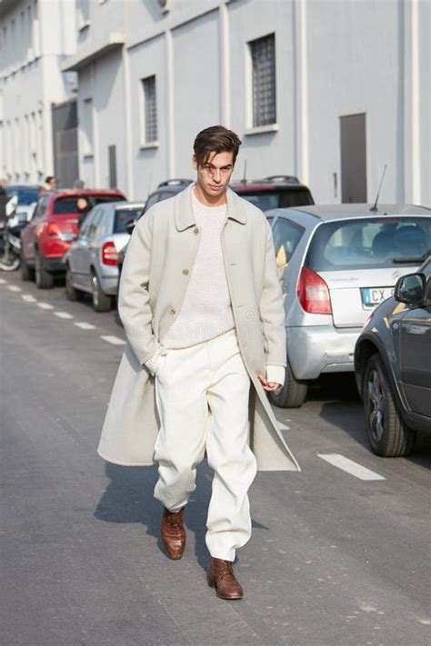 Man With White Trench Coat And Trousers Walking Before Dsquared 2