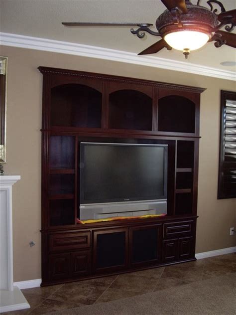 Hiding the tv has historically been designers #1 problem, as well the subject of many. Entertainment Centers - Traditional - Living Room - orange ...