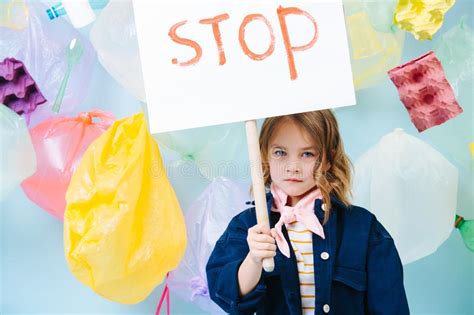 Little Girl Holding Stop Sign In Protest Against Pollution And Waste