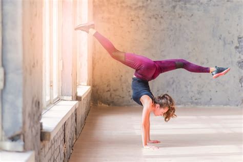 Free Photo Side View Of A Fitness Young Woman Doing Handstand With Splits