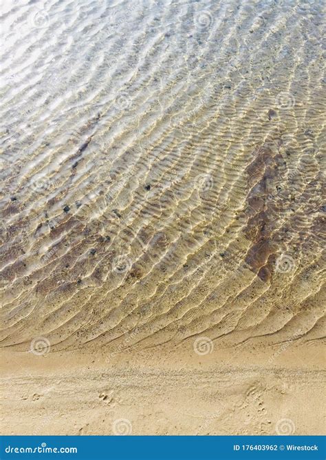 High Angle Shot Of A Sandy Beach And Sea Waves With Interesting