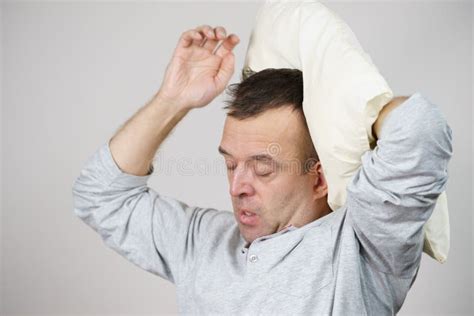 Man Sleepy Tired With Pillow On Grey Stock Photo Image Of Stretching