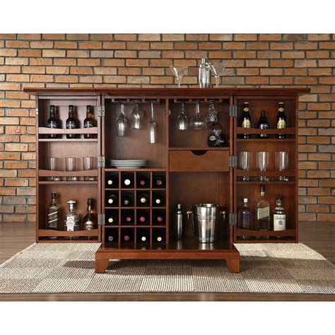 The center cabinet features 16 bottle wine storage, utility drawer, hanging stemware storage, and extra space for a variety of other barware.crosley furniture newport expandable bar Crosley Newport Expandable Bar Cabinet by OJ Commerce $479.00