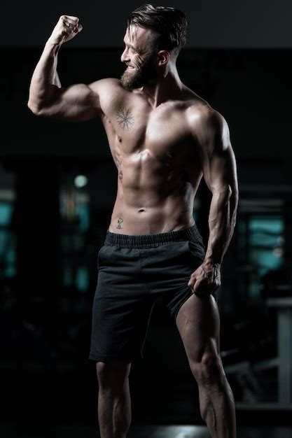 Premium Photo Healthy Young Man Flexing Muscles