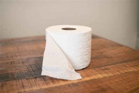 Free Stock Photo Of Open Toilet Paper Roll On Wooden Surface