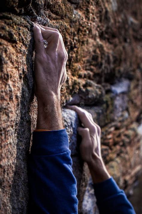 Close Up Of Hands Pinching Small Rock Climbing Holding Stock Photo