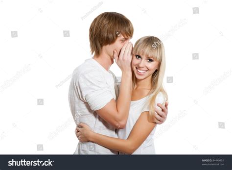 Young Happy Couple Love Smiling Man Telling A Secret To A Girl She