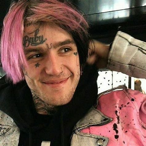 A Man With Pink Hair And Tattoos On His Face