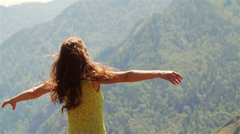 Beautiful Woman Standing On Top Of Mountain And Stretching Out Hands