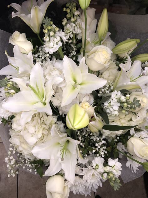 Two beautiful bouquets of mixed flowers in womans hands. White Bouquet - Casablanca Flowers