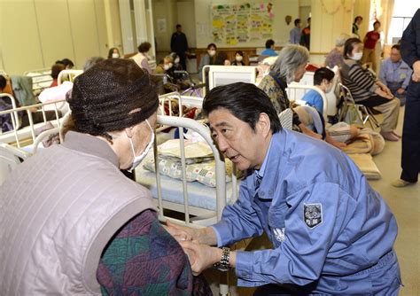 abe visits quake hit kumamoto service on key section of kyushu bullet train line resumes the