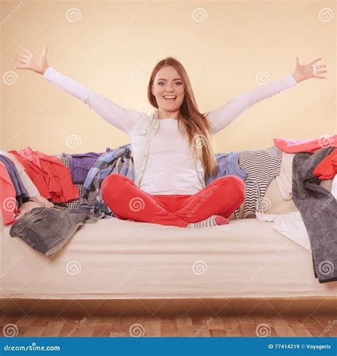 Happy Woman Sitting On Sofa In Messy Room At Home Stock Image Image