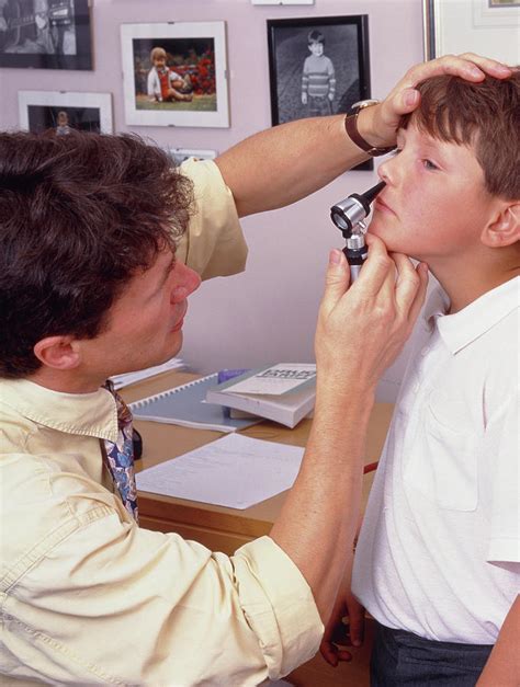 Doctor Examines Boys Nose With Otoscope Photograph By Simon Fraser