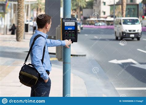 A Man At A Crosswalk With Electronic Regulation Stock Photo Image Of