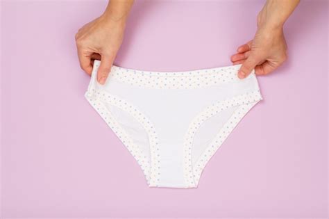 Premium Photo Women S Hands Holding White Cotton Panties On Lilac Background Woman Underwear