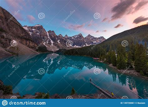 The Moraine Lake With Turquoise Lake And Mountain Reflection In Sunset