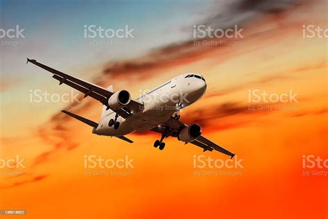 Xl Jet Airplane Landing At Sunset Stock Photo Download Image Now