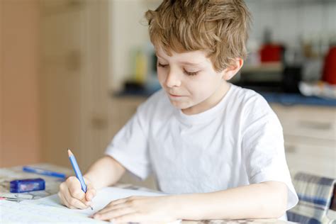 Schoolboy Writing On Book In Classroom Hoodoo Wallpaper