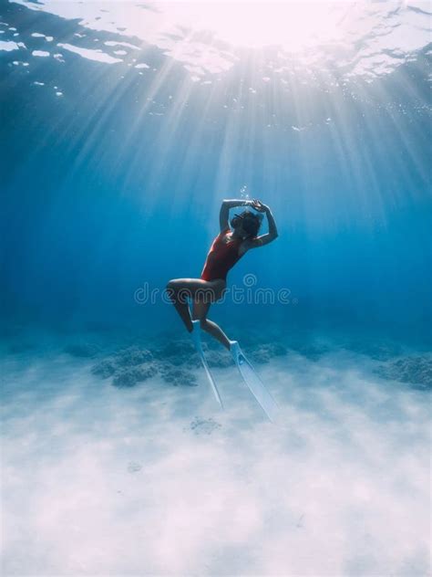 Naked Slim Woman With Freediving Fins Swimming In Blue Ocean Stock Photo Image Of Snorkeling