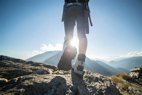 Hiking Feet Againt Sun At Mountain Peak Stock Photo Download Image