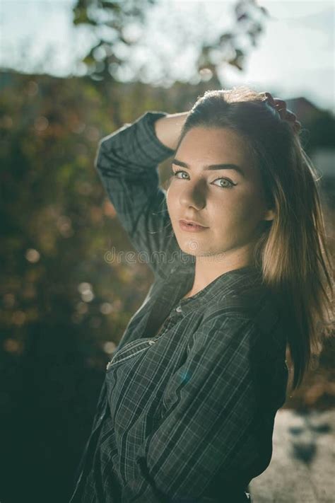 Attractive Bosnian Caucasian Woman Looking At The Camera While Holding