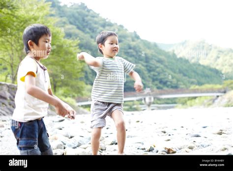 Two Boys Playing In Water Stock Photo Alamy