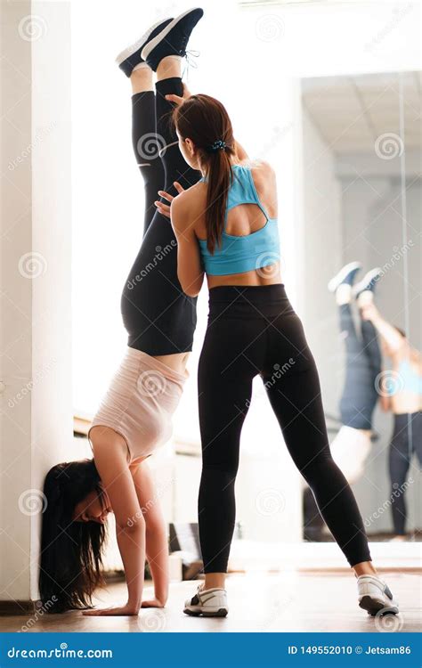 Trainer Helping Sporty Woman To Do Handstand Stock Photo Image Of