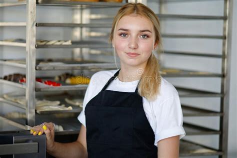 Beautiful Girl In A Cafe And Bakery Holding A Croissant Stock Photo