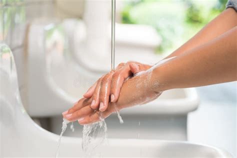 Closeup Woman Washing Hands With Soap Under The Faucet Stock Image
