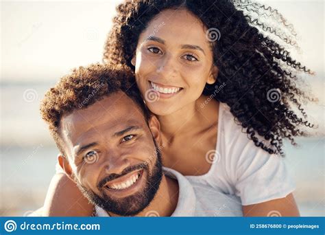Closeup Portrait Of An Young Affectionate Mixed Race Couple Standing On The Beach And Smiling