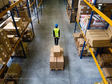 Male Warehouse Worker Pulling A Pallet Truck Warehouse Worker