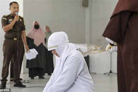 unmarried couple are publicly whipped 21 times each for breaking sharia law in indonesia