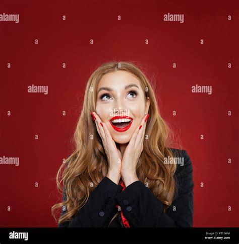 Surprised Woman Happy Girl With Red Lips Makeup Smiling And Looking Up On Empty Red Background