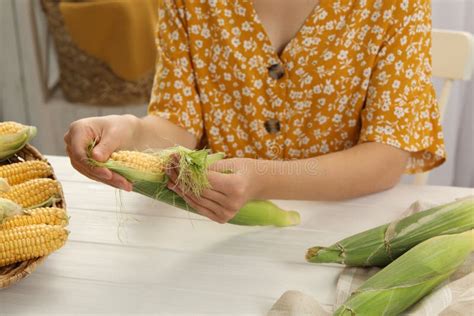 Woman Husking Corn Cob At White Wooden Table Closeup Stock Image Image Of Hand Bunch