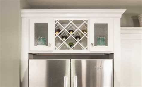 1 glass door flip up wall cabinet (interior will the match wood type and finish chosen for the face of the cabinet) retail price: Wine storage over the refrigerator | Kitchen wine rack ...