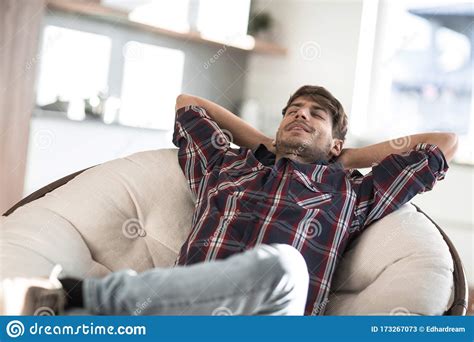 Brooding Young Man Sitting In A Chair Stock Image Image Of Emotions