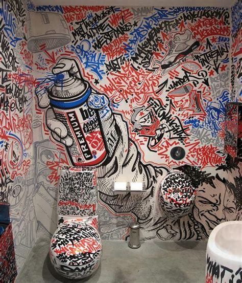 A Bathroom With Graffiti All Over The Walls And On The Wall Is A Urinal