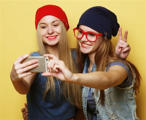 Premium Photo Two Young Hipster Girls Friends Taking Selfie Over