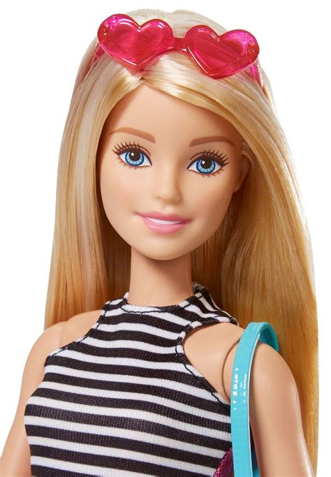 A Barbie Doll With Blonde Hair And Pink Heart Shaped Glasses On Her Head Wearing A Black And