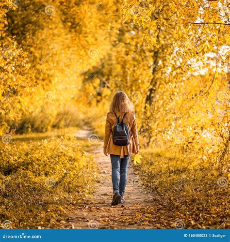 Adult Girl Walking Away Alone On Path In Autumn Forest Lonely Young