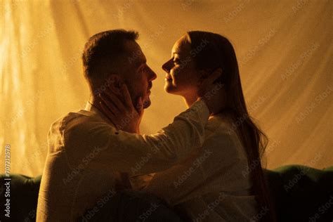 Two Lovers Kissing On Neon Light Background Woman Touching Face Her