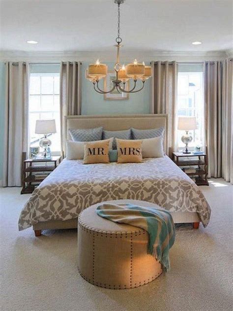 Teal Painted Master Bedroom With A Classic Chandelier Above The Bed
