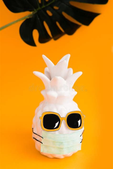 Pineapple In A Medical Mask And Sunglasses On Orange Background Summer