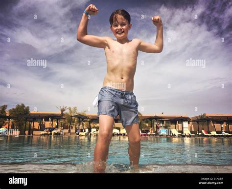 An 11 Year Old Boy Flexes His Muscles After Climbing Out Of A Cold