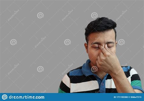Indonesian Guy Weeping In Depressed Mood With Fingers On Both Eyes In