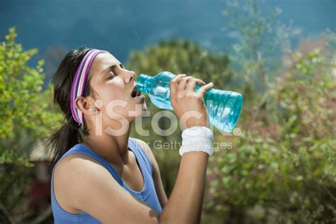 Young Woman Drinking Water After Fitness Exercise Stock Photo