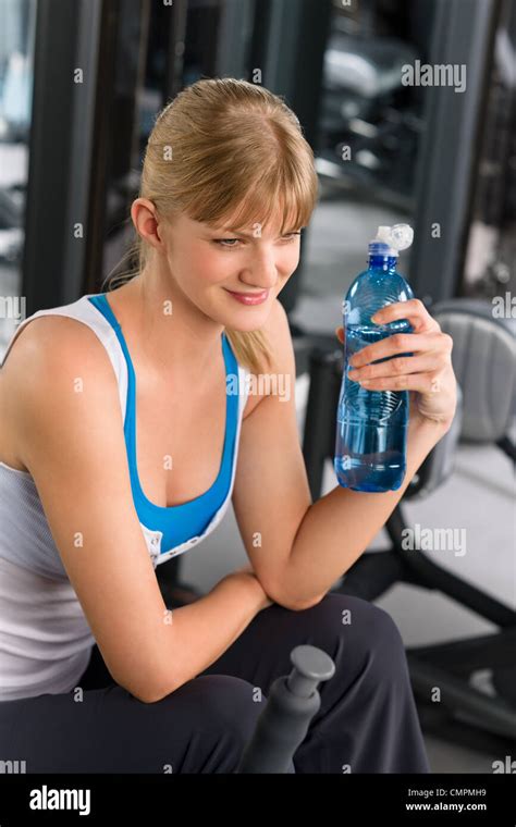 Fitness Club Young Woman Relax At Weight Machine Drink Water Stock