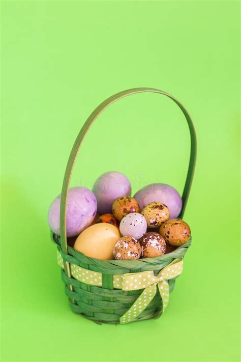 Colorful Easter Eggs In A Basket On Soft Green Background Stock Image
